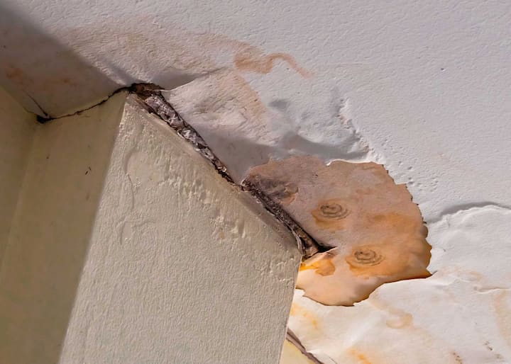 Water damage causing mold from a water leak on a ceiling in Queens, NY